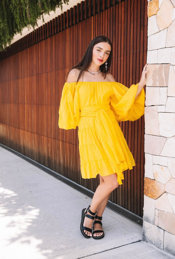 Yellow knee-length dress with long sleeves with tassel belt front campaign 2