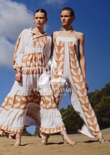 Cotton jumpsuit in white with geometric tan pattern campaign image